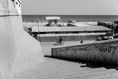 View of built structure by sea