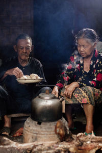 Rear view of woman preparing food at kitchen