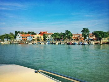 Boats in river with buildings in background