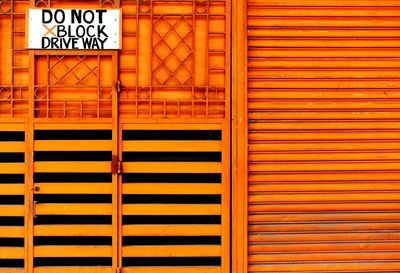 Full frame shot of yellow sign on wall