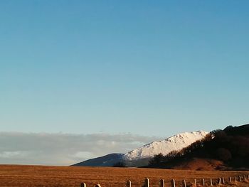 Scenic view of mountains against clear blue sky