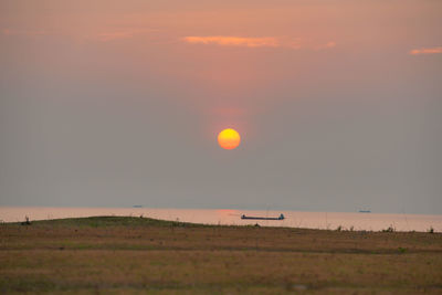 Scenic view of field against sky during sunset