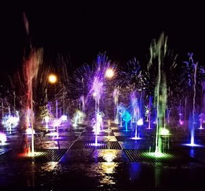 Illuminated fireworks against sky at night