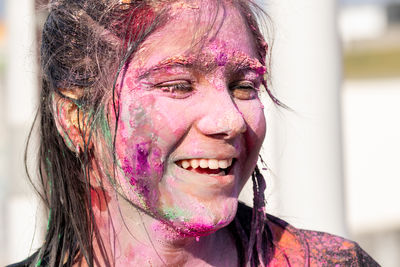 Close up portrait of a girl with color on face