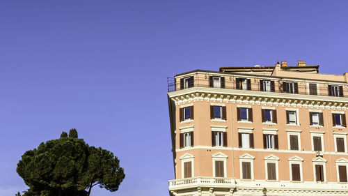 Low angle view of building against clear blue sky