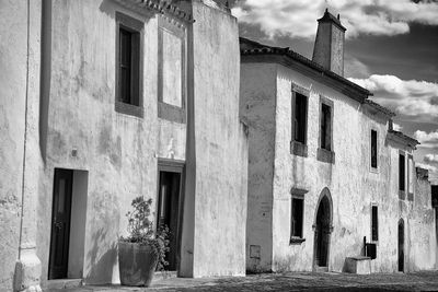 Historic buildings against cloudy sky