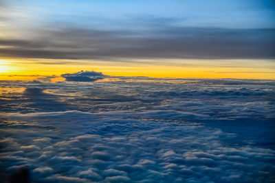 Scenic view of sea against dramatic sky during sunset
