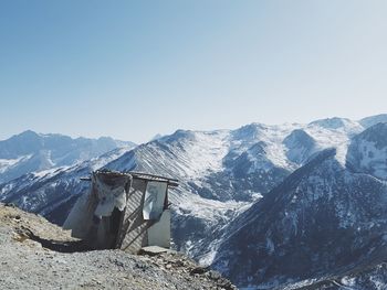 Hut against snowcapped mountains