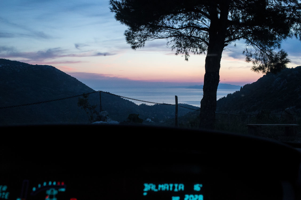 transportation, scenics, mountain, nature, sunset, beauty in nature, car, no people, land vehicle, tree, mode of transport, sky, silhouette, tranquility, landscape, outdoors, day