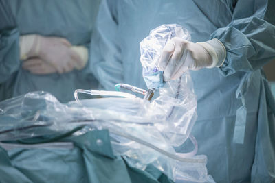 Midsection of surgeon operating patient at hospital