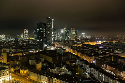 High angle view of illuminated buildings in city at night