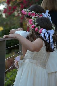 Rear view of cute girl with pink flowers