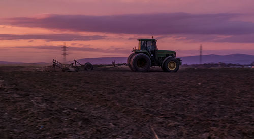 Vintage car on field during sunset