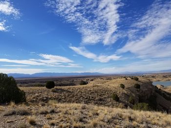 Scenic view of field against blue sky