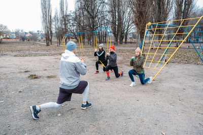 Group fitness workout classes outdoors. socially distant outdoor workout classes in public parks. 