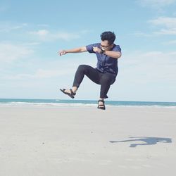 Woman jumping on beach