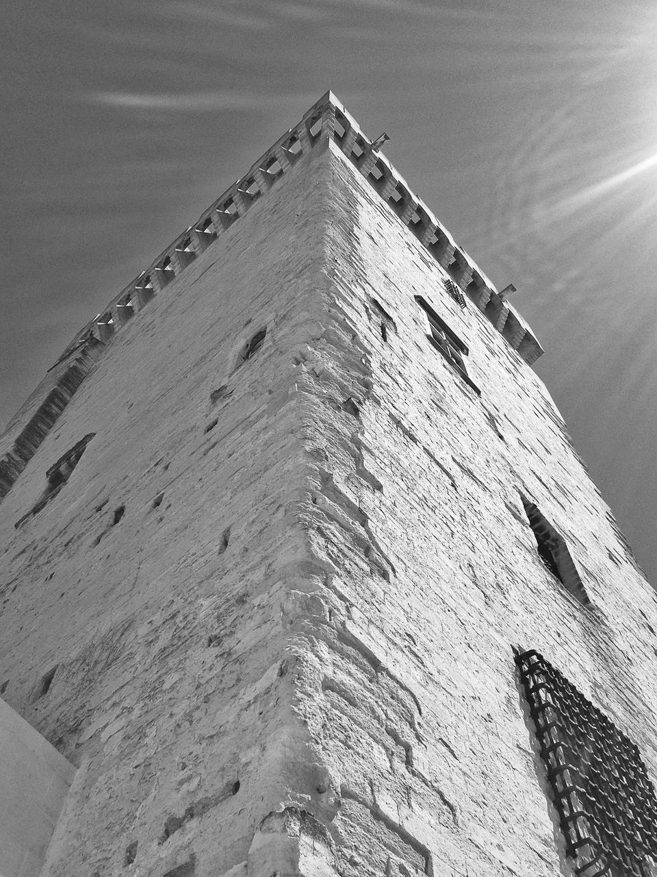 architecture, built structure, building exterior, low angle view, sky, sunlight, day, outdoors, no people, pattern, building, wall - building feature, old, high angle view, house, clear sky, history, nature, tilt, textured