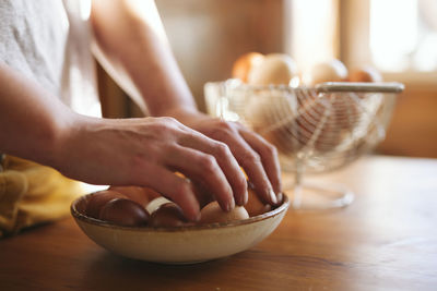 Midsection of woman preparing food on table