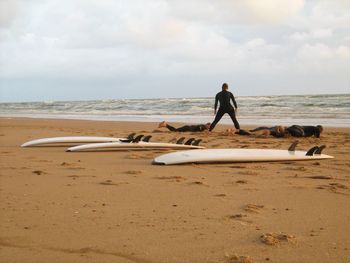 Men on beach against sky