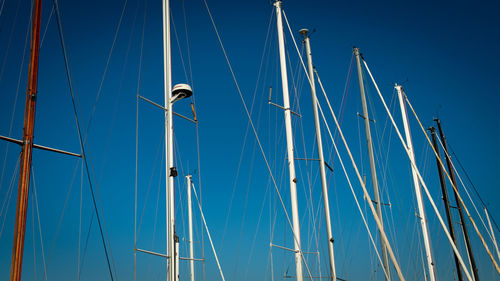 Low angle view of sailboat against blue sky