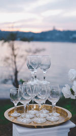 Wine glass at the lake at sunset