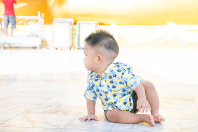 Cute boy looking away on floor