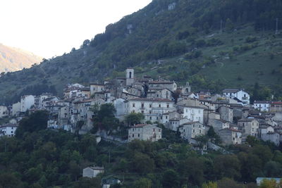 High angle view of townscape and mountains against sky