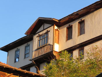 Low angle view of building against clear blue sky
