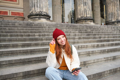 Young woman sitting on steps