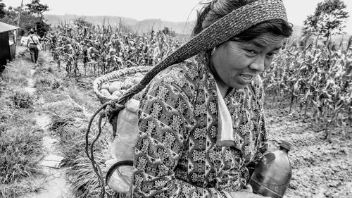 Young woman looking away on field