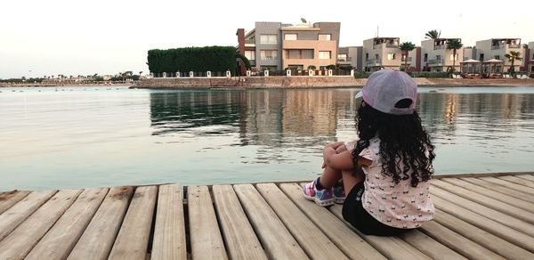 Meditation for cute little girl in the pier