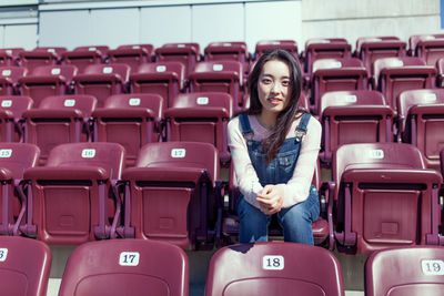 Woman sitting on stadium seat