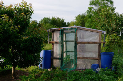Built structure on field against trees
