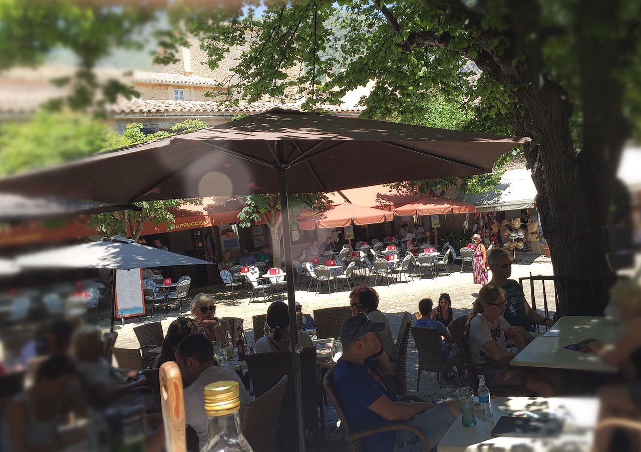 tree, hanging, religion, market, retail, focus on foreground, for sale, built structure, market stall, architecture, day, spirituality, building exterior, selective focus, large group of people, place of worship, outdoors, tradition, abundance, incidental people