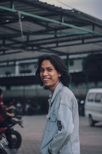 Portrait of a smiling young woman in city