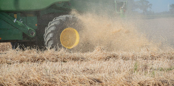 Combine harvester harvesting crops on agricultural field