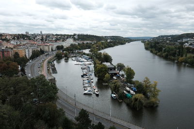 High angle view of river amidst city against sky