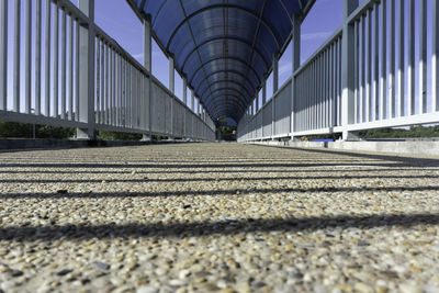 Surface level of footpath against sky in city