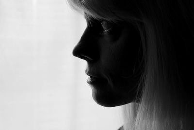 Close-up portrait of young woman looking away