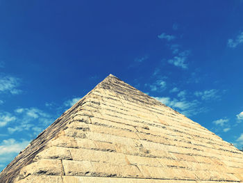 Low angle view of historical building against blue sky