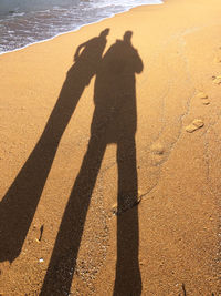 Shadow of people on beach