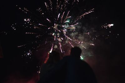 Low angle view of firework display at night