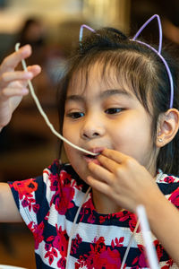 Cute girl eating food at restaurant