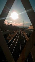 Railroad tracks against sky during sunset