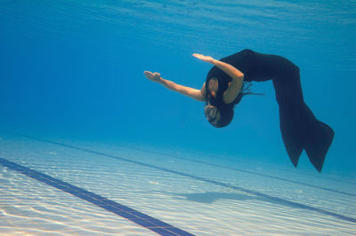 Female model swimming in pool