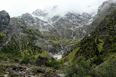 Scenic view of waterfall against sky