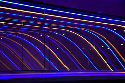 Low angle view of illuminated light trails at night