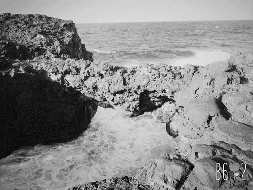 sea, water, horizon over water, wave, rock - object, scenics, beach, beauty in nature, rock formation, shore, surf, tranquil scene, nature, tranquility, rock, idyllic, cliff, coastline, clear sky, motion