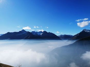 Scenic view of mountains against blue sky