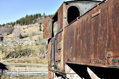 Train by railroad tracks against clear sky